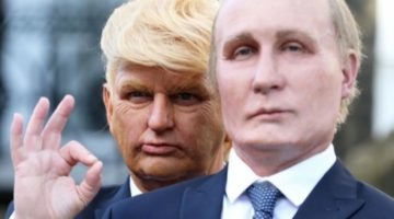 A Donald Trump impersonator stands behind and over the shoulder of a Vladimir Putin impersonator.